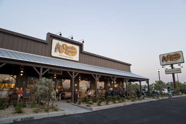 Customers sit in signature rocking chairs outside during the grand opening of Las Vegas' first Cracker Barrel location near the Silverton Hotel-Casino on Monday, July 25, 2016. The line to get in ...