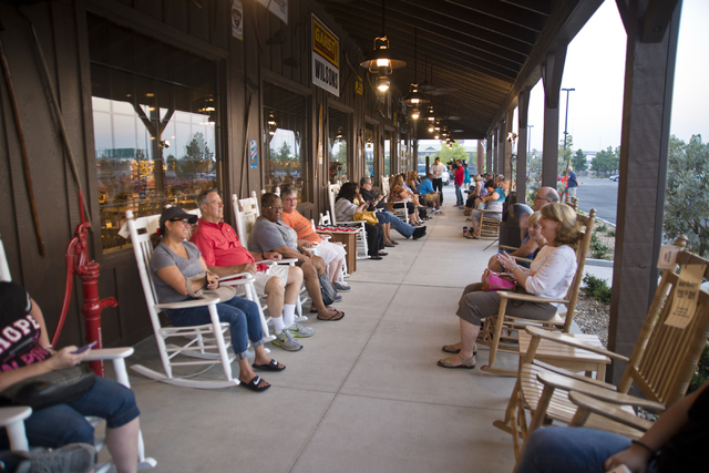 Customers sit in signature rocking chairs outside during the grand opening of Las Vegas' first Cracker Barrel location near the Silverton Hotel-Casino on Monday, July 25, 2016. The line to get in  ...