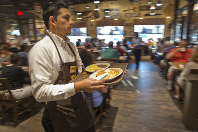 Charle Quintal brings out food orders during the grand opening of Las Vegas' first Cracker Barrel location near the Silverton Hotel-Casino on Monday, July 25, 2016. The line to get in stretched in ...