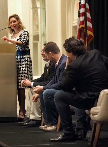 Moderator Shane Tews listens as panelists Michael Kaczmarek, Scott McCormick and Ian C. Ballon, left to right, discuss cyber security details with business owners at a breakfast meeting sponsored ...