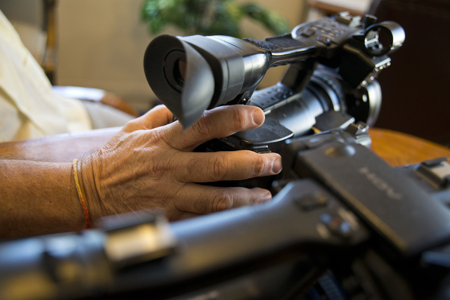 Richard Kashanski, a local videographer, places his hand on one of his cameras while speaking with a reporter in his Henderson home on Monday, July 11, 2016. Kashanski is part of a team that has h ...