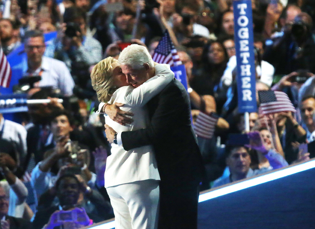 Democratic presidential nominee Hillary Clinton, left, hugs husband former President Bill Clinton during the final day of the Democratic National Convention at the Wells Fargo Center on Thursday, ...