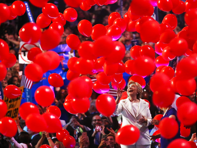 Democratic presidential nominee Hillary Clinton walks off stage through a sea of balloons during the final day of the Democratic National Convention at the Wells Fargo Center on Thursday, July 28, ...