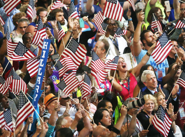 The crowd erupts as Democratic presidential nominee Hillary Clinton walks on stage during the final day of the Democratic National Convention at the Wells Fargo Center on Thursday, July 28, 2016, ...