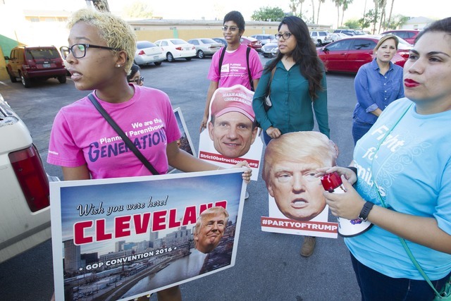 Protesters, from left, Hana Gutierrez, Raul Chavez, Erika Castro and Astrid Silva wait for U.S. Rep. Joe Heck, R-Nev., to arrive at a breakfast meeting in Las Vegas on Wednesday, July 20, 2016. (R ...