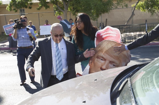 Protester Erika Castro, center, scuffles with security of U.S. Rep. Joe Heck, R-Nev. following at a breakfast meeting hosted by the non-partisan organization Hispanics In Politics. (Richard Brian/ ...