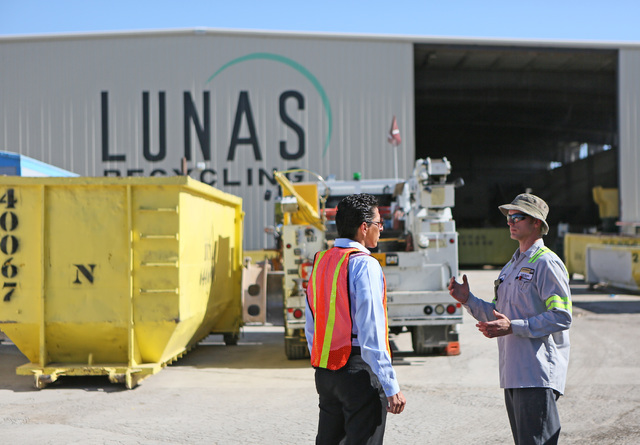 Norberto Madrigal, co-owner of Lunas Recycling, left, speaks with Cashman Cat field service technician, Jason Bateman, at Lunas Recycling Monday, July 18, 2016, in Las Vegas. The family-owned wast ...