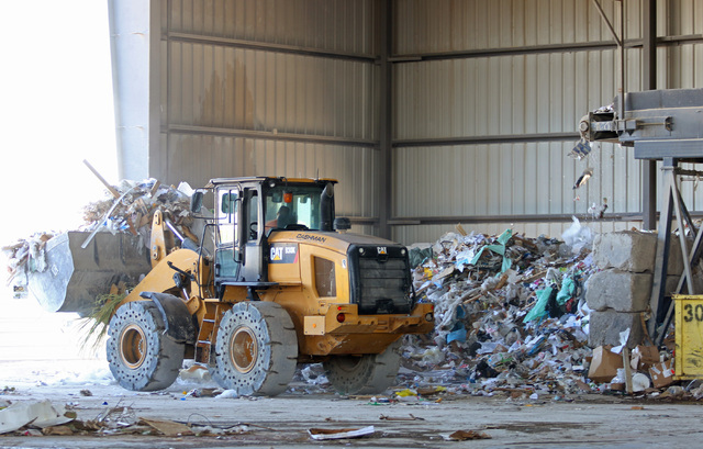 A worker uses a front end loader in the materials recovering facility at Lunas Recycling Monday, July 18, 2016, in Las Vegas. The family-owned waste management facility is located at 4830 E. Carti ...