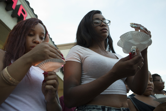 Renae Copeland, right, and unidentified woman pay their respects at a candlelight vigil for the victims of a murder-suicide on Friday, July 1, 2016 in Las Vegas. Loren Townsley/ Las Vegas Review-J ...