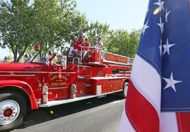Las Vegas City Councilman Ricki Barlow, back left, rides in a fire truck with family during the 22nd Annual Summerlin Council Patriotic Parade Monday, July 4, 2016, in Las Vegas. (Ronda Churchill/ ...
