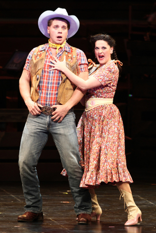 Spudbuster Whip Masters (Nathaniel Hackmann), left, and Crazy Betty Felter (Holly Holcomb) join the opening number, "Heck It's A Helluva Day," during The Smith Center's "Idaho! The Comedy Musical. ...