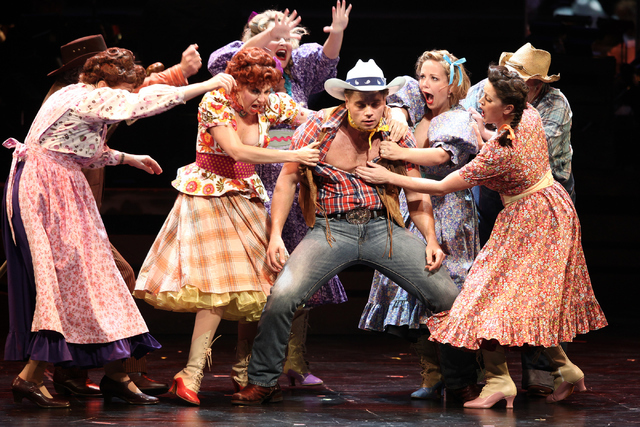 Whip Masters (Nathaniel Hackmann), center, joins fellow Idahoans to celebrate the fact that "Heck It's A Helluva Day," the opening number in The Smith Center's new musical "Idaho!" Loren Townsley/ ...