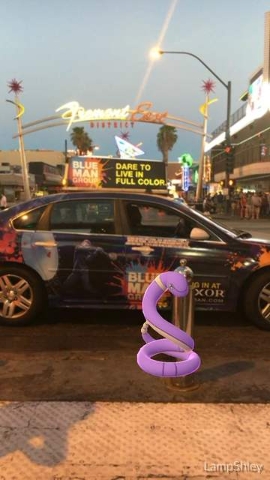 An Ekans is seen at the Fremont Street Experience on the screen of a Pokemon Go user in downtown Las Vegas, on Wednesday, July 13, 2016. (Ashley Casper/Las Vegas Review-Journal)