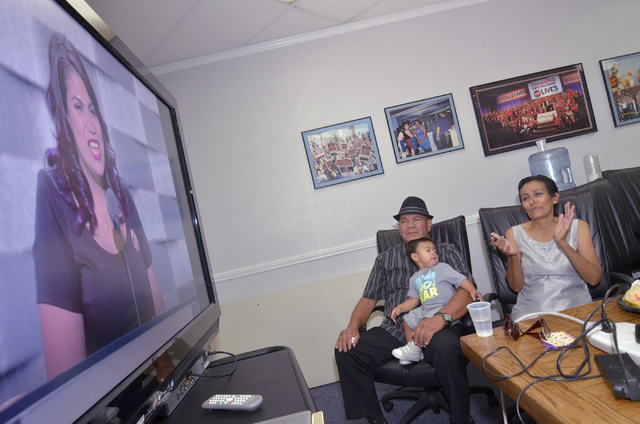 Carlos and Barbara Silva watch with their grandson Noah as their daughter Astrid speaks at the Democratic National Convention during a viewing party at Culinary Workers Union Local 226 at 1630 S.  ...