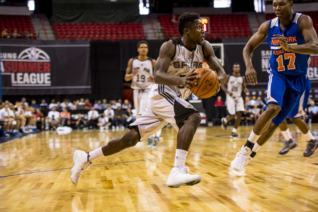 Will Cherry, (56) of the San Antonio Spurs, drives to the net against Cleanthony Early, (17) of the New York Knicks, during the NBA Summer League at the Thomas & Mack Center in Las Vegas on Sa ...