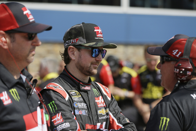 Driver Kurt Busch talks to a crew member after qualifying for the NASCAR Sprint Cup series auto race at Michigan International Speedway, Friday, June 10, 2016 in Brooklyn, Mich. (Carlos Osorio/AP)