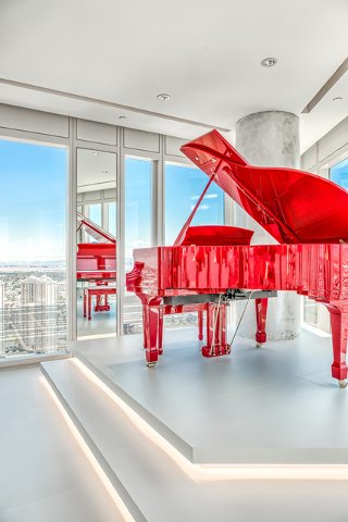 In the main living room is a bright red Pramberger Legacy Series player piano. (Courtesy of Luxury Estates International)