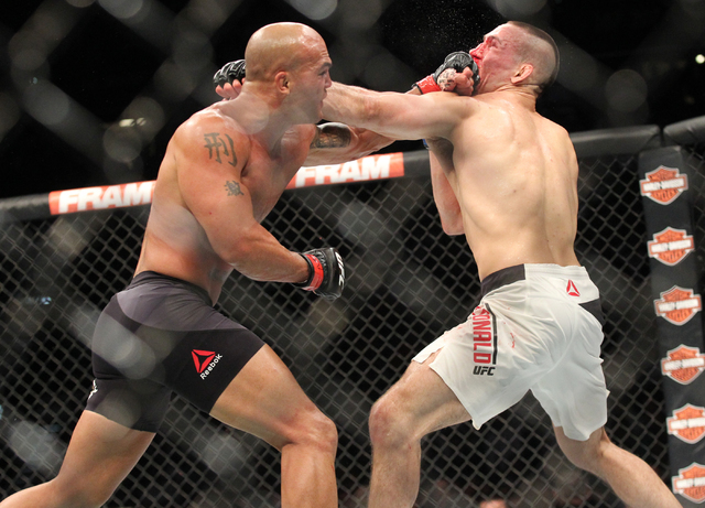 Robbie Lawler, left, trades jabs with Rory MacDonald during their welterweight title bout at UFC 189 at the MGM Grand Garden Arena Saturday, July 11, 2015, in Las Vegas. Lawler won by technical kn ...
