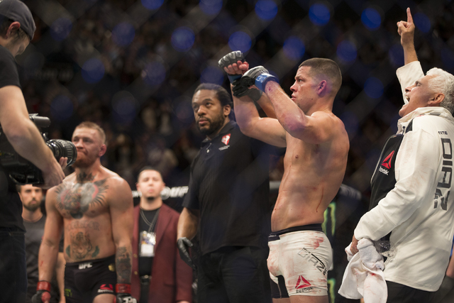 Nate Diaz, right, celebrates his win against Conor McGregor in their menճ welterweight title bout during UFC 196 at MGM Grand Garden Arena on Saturday, March 5, 2015 in Las Vegas. Diaz won b ...