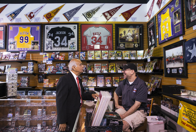 Neonopolis owner Rohit Joshi, left, talks business with Rob Vandorick, store manager at Ultimate Sports Cards and Memorabilia, on Tuesday, July 12, 2016, in Las Vegas. Benjamin Hager/Las Vegas Rev ...