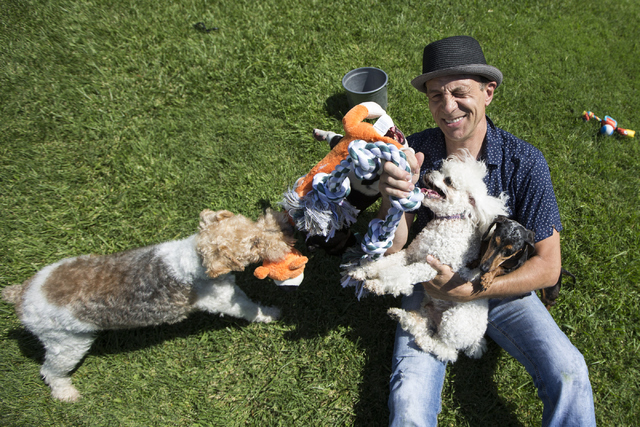 Gregory Popovich plays with his dogs at his North Las Vegas home June 24. Erik Verduzco/View
