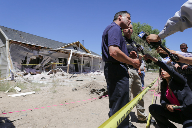 Nevada Governor Brian Sandoval, center, speaks to the media and community members with Lincoln County Sheriff Kerry Lee on Friday, July 15, 2016, at the attacked house in Panaca, Nev., about the W ...