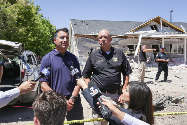 Nevada Governor Brian Sandoval, left, speaks to the media and community members with Lincoln County Sheriff Kerry Lee on Friday, July 15, 2016, at the attacked house in Panaca, Nev., about the Wed ...