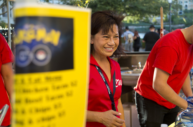 Chanthy Walsh helps serve food during a Pokemon Go &quot;Meet and Eat&quot; event at Lake Las Vegas on Tuesday, July 19, 2016. The event was organized by Walsh who owns two restaurants ins ...