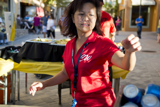 Chanthy Walsh helps serve food during a Pokemon Go &quot;Meet and Eat&quot; event at Lake Las Vegas on Tuesday, July 19, 2016. The event was organized by Walsh who owns two restaurants ins ...