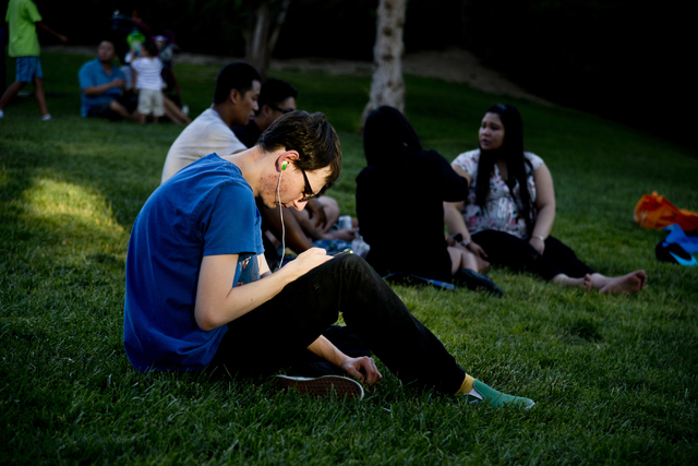 Dylan Gilbert uses the Pokemon Go app during a Pokemon Go &quot;Meet and Eat&quot; event at Lake Las Vegas on Tuesday, July 19, 2016. The event was organized by Chanthy Walsh who owns two  ...