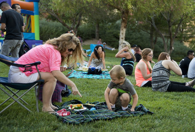 Christine DeRoss and her son Lane get ready to eat during a Pokemon Go &quot;Meet and Eat&quot; event at Lake Las Vegas on Tuesday, July 19, 2016. The event was organized by Chanthy Walsh  ...