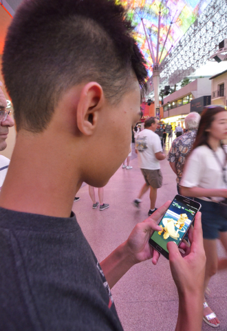 Kolby Stevenson of Las Vegas plays "Pokemon Go" along the Fremont Street Experience in downtown Las Vegas on Wednesday, July 13, 2016. (Bill Hughes/Las Vegas Review-Journal)