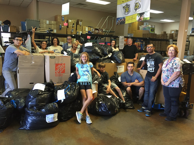 Channel 8 employees and Project 150 volunteers show off the items collected during a donation drive to benefit the nonprofit in June 2016. Special to View