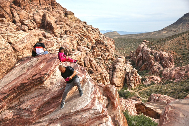 Visitors to Red Rock Canyon Conservation Area scale steep rocks to get the best view Sunday, March 13, 2016. (Benjamin Hager/Las Vegas Review-Journal) @benjaminhphoto