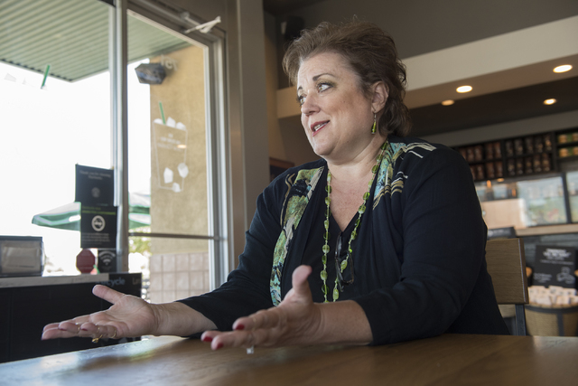 Julie Davies talks to a reporter during an interview regarding the city's licensing and zoning regulations on short-term residential rentals from a Starbucks on North Rancho Drive in Las Vegas, on ...