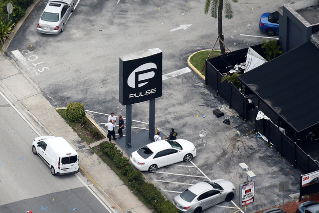Investigators work the scene following a mass shooting at the Pulse gay nightclub in Orlando Florida, U.S. June 12, 2016. (Carlo Allegri/Reuters)