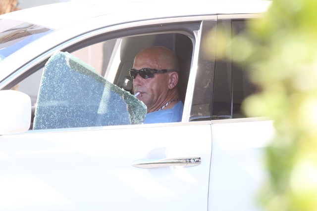 Retired police officer from New York City Neil Levine sits in his vehicle as Las Vegas police investigate an attempted armed robbery outside the Rumor Boutique Hotel at 455 E. Harmon Ave., where L ...