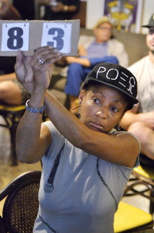 Judge Ginger Jones holds up her score card during a poetry slam sponsored by the Battle Born slam poetry team at The Beat Coffeehouse and Records at 520 Fremont St. in Las Vegas on Friday, July 22 ...