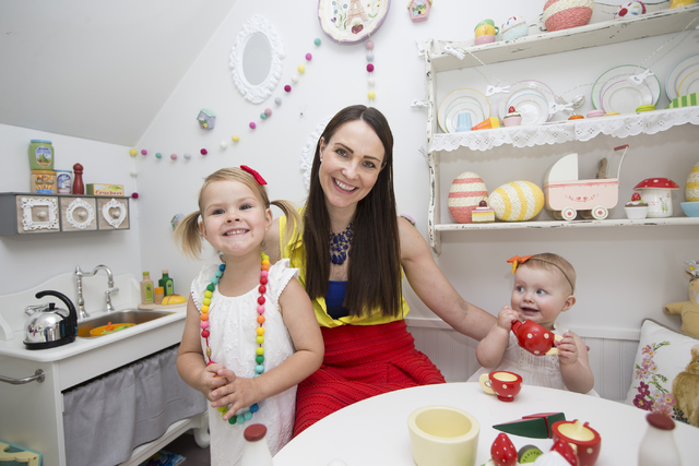 Interior designer Jannicke Ramso, owner of Tiny Little Pads, poses for a portrait with daughters Nahla, 3, and Miliah, 11 months, inside a playhouse she designed and her husband helped build at th ...