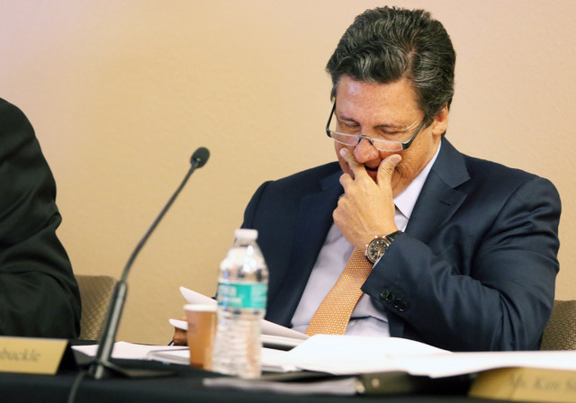 Southern Nevada Tourism Infrastructure Committee member William Hornbuckle, president of MGM Resorts International, looks over paperwork a SNTIC meeting at UNLV's Stan Fulton Building Monday, July ...