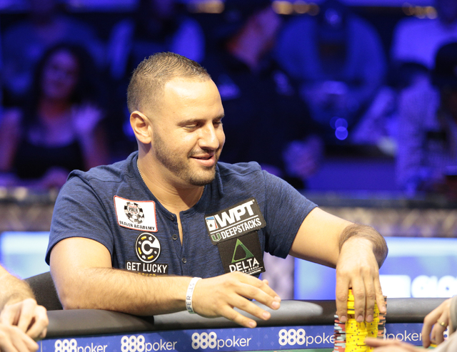 Michael Mizrachi smiles and stacks his chips after winning a hand in the $50,000 buy-in Poker Players' Championship at the Rio Convention Center in Las Vegas on Wednesday, July 6, 2016. (Donavon L ...