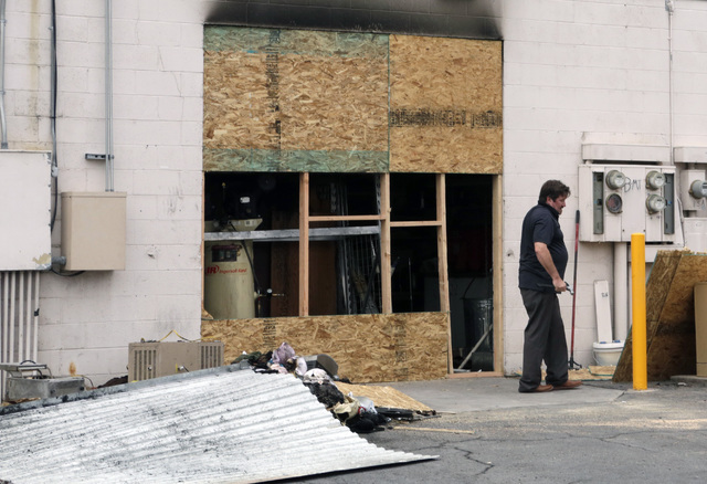 A worker is seen on Friday, July 29, 2016, boarding up a storage facility damaged by a fire at 3111 S. Valley View Blvd. on Thursday night. One firefighter was injured. (Bizuayehu Tesfaye/Las Vega ...