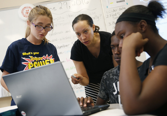 Crystal Nunes, second from left, works with students at Rebel Academy in North Las Vegas on June 29. Rebel Academy, spearheaded by UNLV's College of Education, is a project to give prospective tea ...