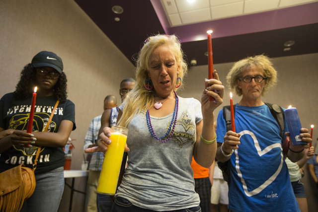 Venus Heard closes her eyes for a prayer during a candlelight vigil honoring the victims of the Orlando mass shooting at The Gay and Lesbian Community Center of Southern Nevada June 12, 2016, in L ...