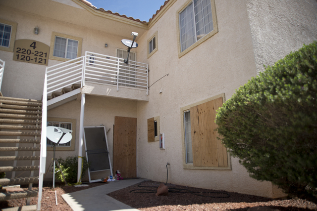 The apartment where Jason Dej-Oudom killed himself and his three children on Wednesday night is seen with boards across the windows and front door in Las Vegas on Friday, July 1, 2016. Dej-Oudom a ...