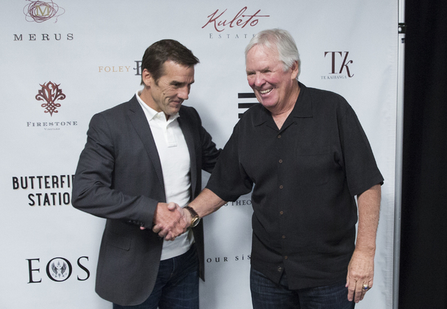 Bill Foley, right, owner of Las Vegas’ NHL expansion team, shakes hands with George McPhee, the team's new general manager, at T-Mobile Arena on Wednesday, July 13, 2016, in Las Vegas. (Benjamin ...