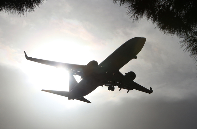 The sun shines through dust and clouds as an American Airlines jet makes its approach to McCarran International Airport on Monday, March 28, 2016. (Bizuayehu Tesfaye/Las Vegas Review-Journal Follo ...