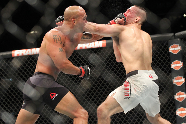 Robbie Lawler, left, trades jabs with Rory MacDonald during their welterweight title bout at UFC 189 at the MGM Grand Garden Arena Saturday, July 11, 2015, in Las Vegas. Lawler won by technical kn ...