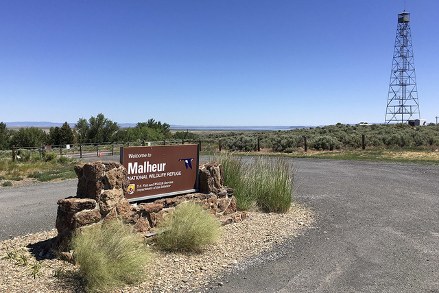 This photo taken June 21, 2016, shows a locked gate that blocks the road at the headquarters of the Malheur National Wildlife Refuge near Burns, Ore., more than four months after the last occupier ...