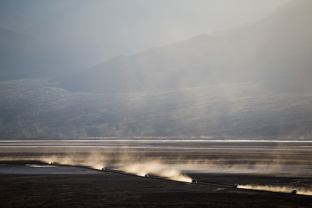 Cars drive on a dirt road off of Badwater Road in Death Valley National Park, Calif., on Saturday, Feb. 27, 2016. The National Park Service said in a statement that the "current bloom in Death Val ...